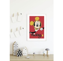 Gerahmtes Mickey Maus Poster an einer Wand über einem Tisch mit dekorativen Elementen