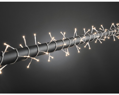 Guirlande lumineuse Micro Konstsmide 160, blanc chaud, câble transparent Guirlande lumineuse enroulée autour d''un tuyau