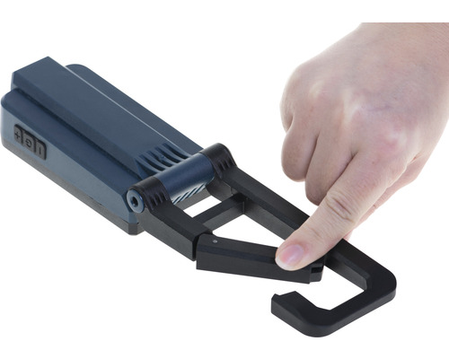 Hand die einen mobilen LED-Baustrahler bedient