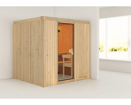 Elementsauna Karibu Sodina ohne Ofen und Dachkranz mit bronzierter Ganzglastür Holzsauna mit Glastür und Inneneinrichtung in einem hellen Raum