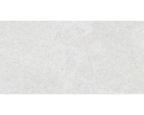 Detailansicht einer hellen Bodenfliese mit gesprenkelter Textur