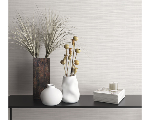 Dekoratives Stillleben mit Vasen, Ziergräsern, Buch und Kerze auf einem Regal