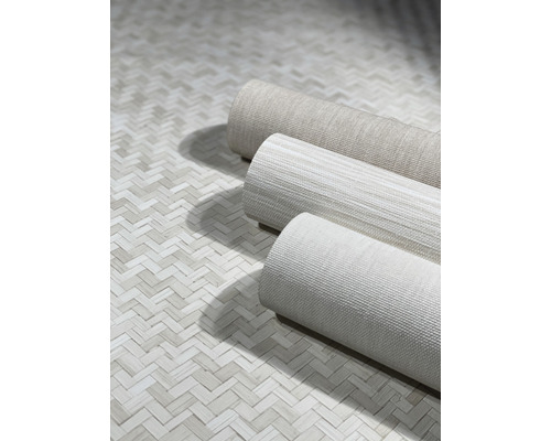 Drei Rollen Textiltapeten auf einem Boden mit Fischgrätmuster