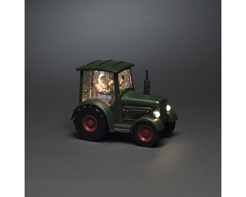 Boule à neige décorative avec le père Noël dans un tracteur