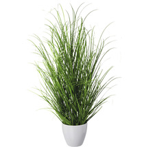 Gazon artificiel en pot blanc comme décoration de pièce