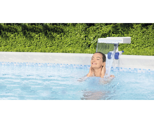 Femme se détend dans la piscine sous une cascade