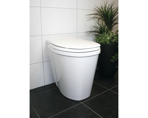 Urinoir SEPARETT Pee blanc H-1264-01 WC sur pied blanc avec réservoir de chasse d''eau devant des carreaux muraux et une plante d''intérieur