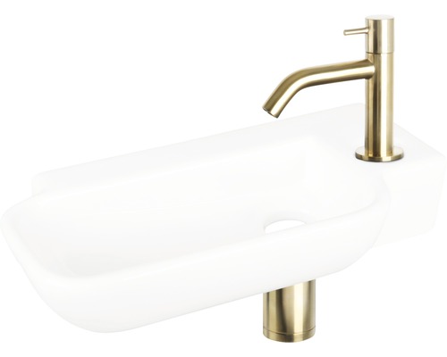Weisses Waschbecken mit goldfarbener Armatur für das Badezimmer
