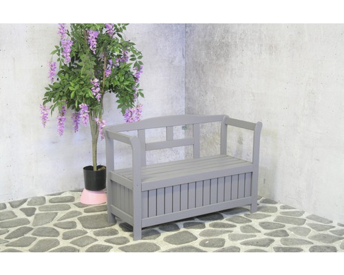 Graue Gartenbank mit Stauraum und dekorativer Pflanze
