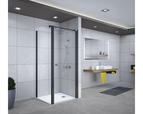 Salle de bains avec cabine de douche à cadre noir, lavabo et miroir