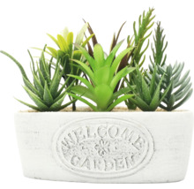 Plantes artificielles décoratives dans un pot portant l''inscription Jardin de bienvenue