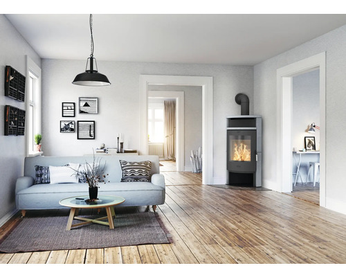 Salon avec canapé, poêle à bois et suspension pour une ambiance chaleureuse