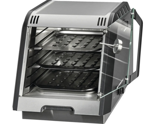 Four multifonction avec trois grilles et une porte en verre ouverte