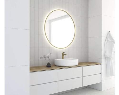 Salle de bains moderne avec miroir rond, meuble-lavabo, vasque et robinet.
