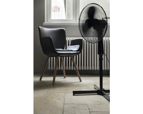 Zimmeransicht mit einem schwarzen Stuhl, einem Ventilator und einem Heizkörper