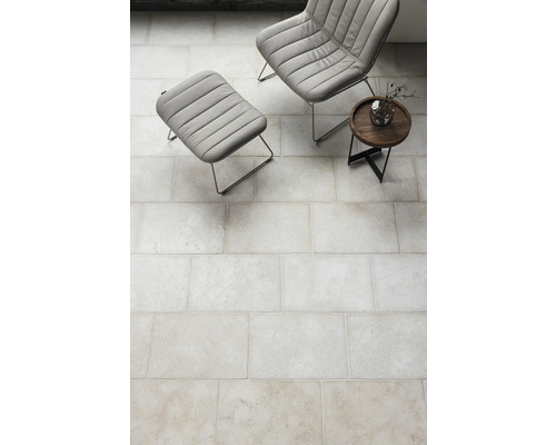 Sol carrelé à l''intérieur avec fauteuil et table d''appoint.