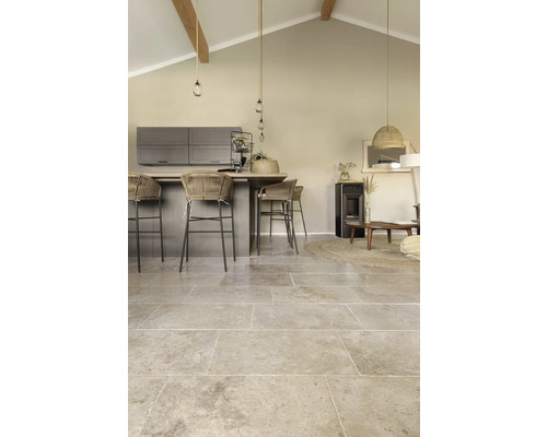 Wohnraum mit Bodenfliesen in Natursteinoptik, Kücheninsel und Sitzgelegenheiten.