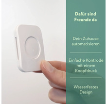Weißer Taster zur Hausautomation in der Hand