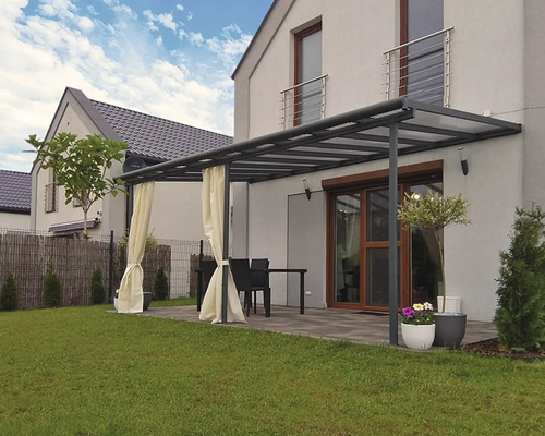 Terrasse couverte avec rideaux, table et chaises dans le jardin