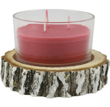 Bougie à trois mèches dans un verre sur un dessous de plat en bois