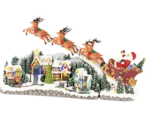 Décoration de village de Noël avec le Père Noël dans un traîneau et des rennes