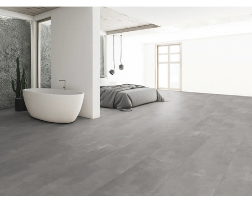 Chambre lumineuse avec baignoire îlot et carrelage gris