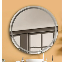 Miroir rond avec cadre dans une salle de bain