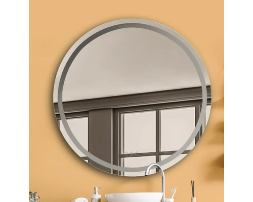 Miroir rond avec cadre dans une salle de bain