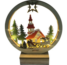 Décoration de Noël illuminée avec le Père Noël en traîneau devant un paysage de maisons